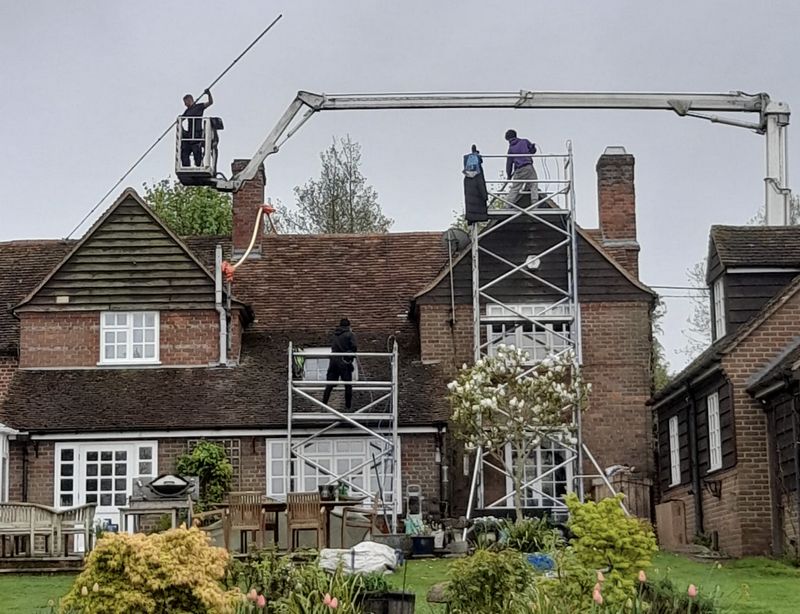 The Roof Moss Cleaners using cherry picker and scaffolding to clean roof safely and professionally in Melksham, Wiltshire